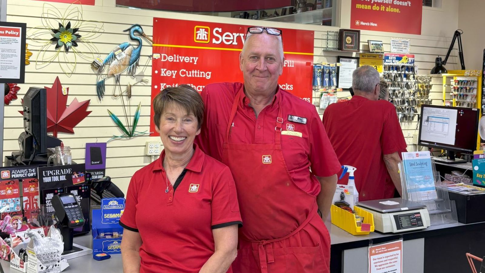 Home Hardware employees smiling at the counter.