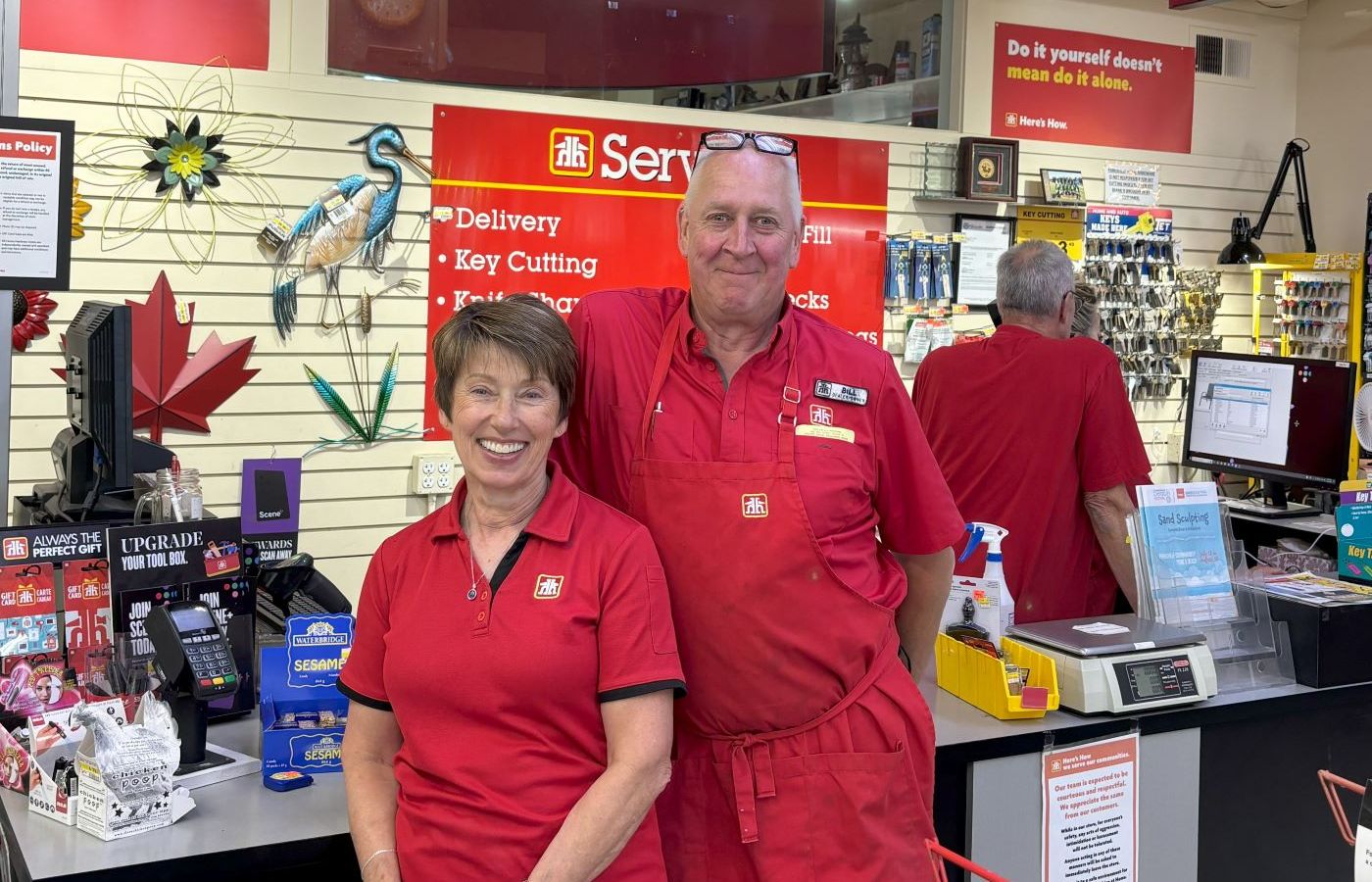 Home Hardware employees smiling at the counter.