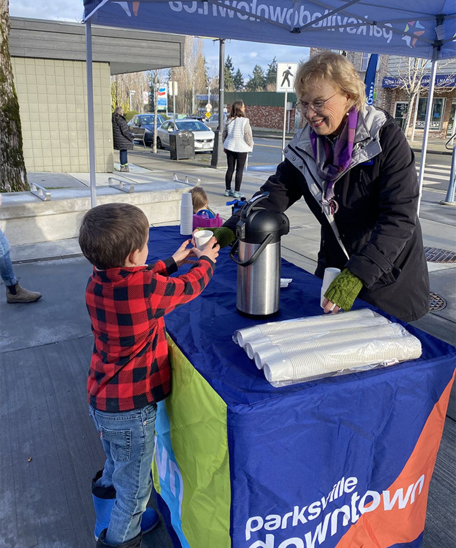 Parksville Downtown volunteer helping child in downtown Parksville