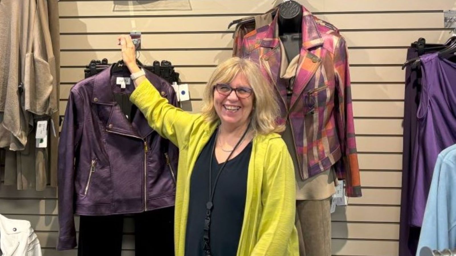 Close to You employee smiling at the clothing section of the store.