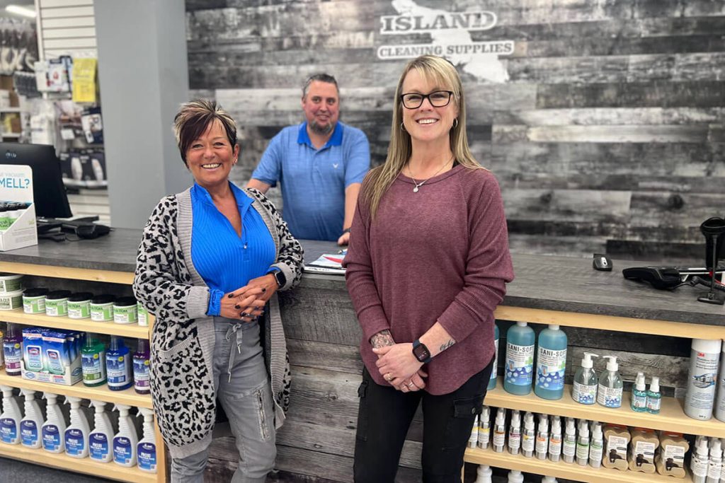 Staff of Island Cleaning Supplies standing in front of counter, smiling